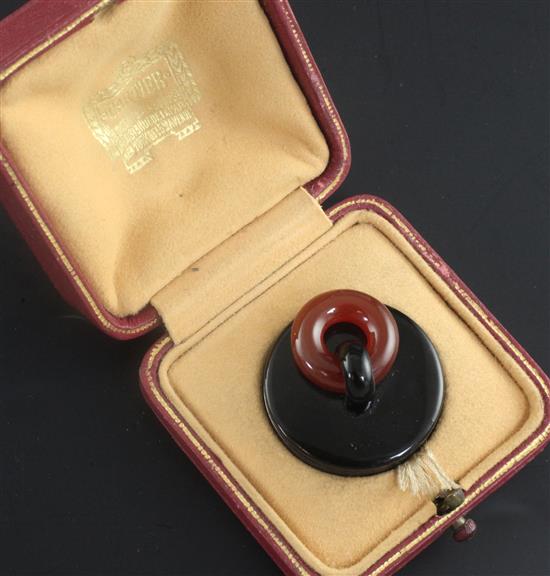 A cased mid 1930s French Cartier silver, black enamel and carnelian plug pill box, 3cm.